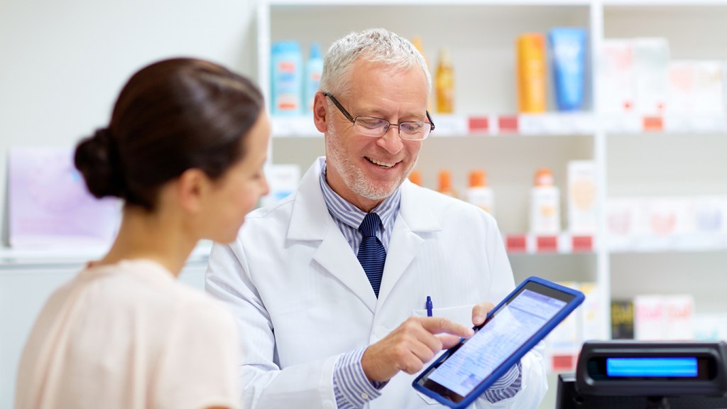 GP showing prescription to pharmacist in the Pharmacy
